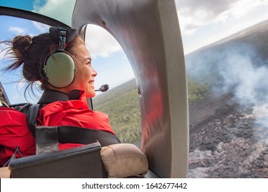 Helicopter Doors Off Ride Adventure Travel Asian Woman Tourist Happy Looking At Landscape Of Volcanic Eruption Above Volcano Fumes In Big Island, Hawaii.