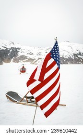 Helicopter drops off tourists at a dog sled camp at Alaska's Norris Glacier