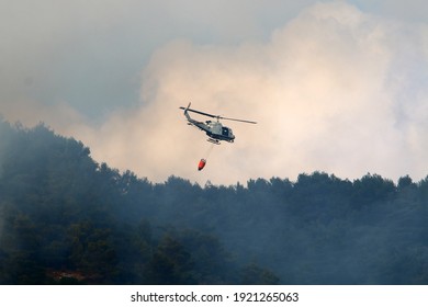 A helicopter extinguishes a forest fire on the Israeli-Lebanese border.