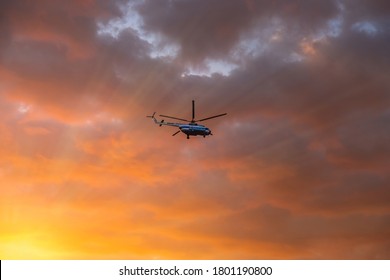 The helicopter flies in the sky
