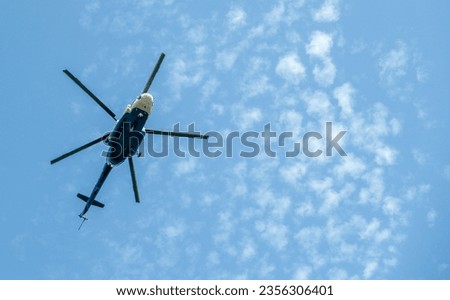 Helicopter in flight against the blue sky