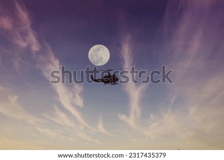 Helicopter in flight with moon background 