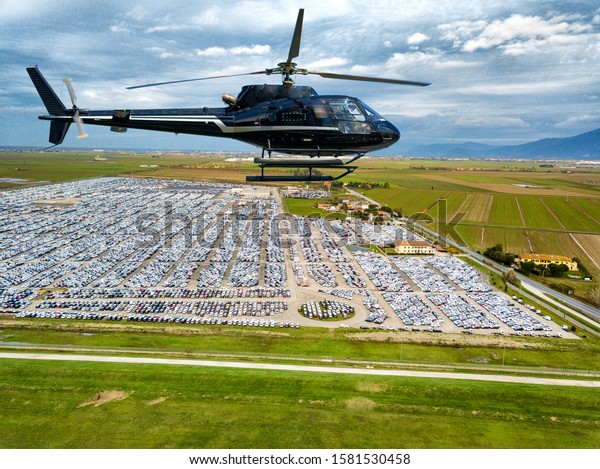 Helicopter flight over\
customs car\
parcking.