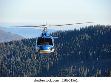 Helicopter flying above forest                                - Powered by Shutterstock