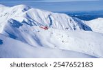 A helicopter flying above mountains patrolling the area