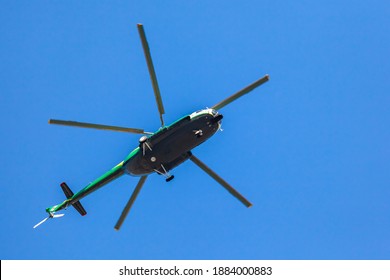 Helicopter Flying Against The Blue Sky, Rotary Wing Aircraft Flying To Transport