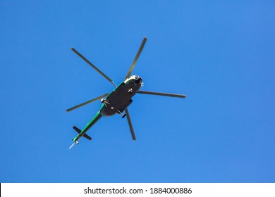 Helicopter Flying Against The Blue Sky, Rotary Wing Aircraft Flying To Transport