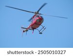 Helicopter flying over the beach at Sanibel Island.