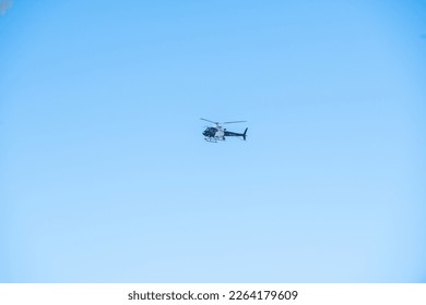Helicopter flying over the ocean in California.