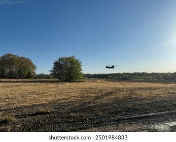 Helicopter flying over a rural landscape during early morning in a clear sky - Powered by Shutterstock