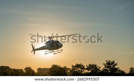 Helicopter flying with the sun as a background