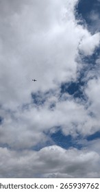 A Helicopter Gracefully Gliding Through a Dramatic, Cloudy and Beautiful Sky Above Us
