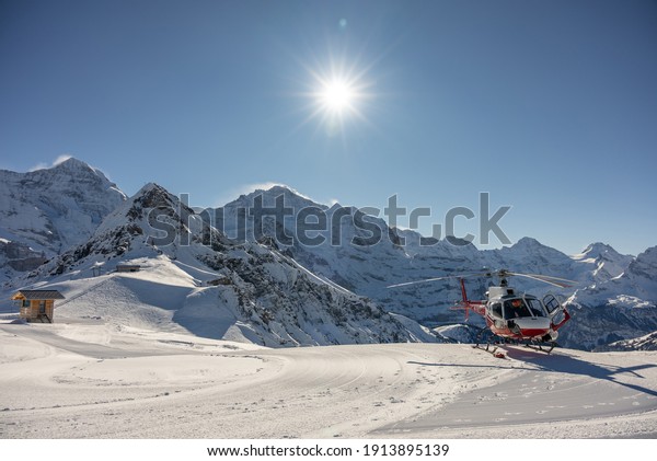 Helicopter in the  hihg\
mountains, helicopter in the swiss alps in Jungfrauregion in\
Switzerland