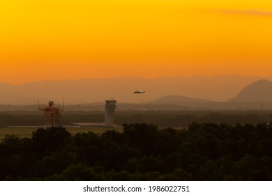 Helicopter landing at the airport in Vitoria-ES. Sunset in the city, showing the airport's radar and control tower. - Powered by Shutterstock