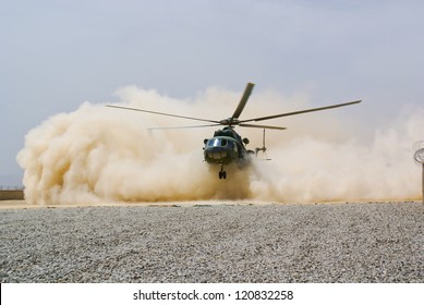 Helicopter Landing In Cloud Of Dust