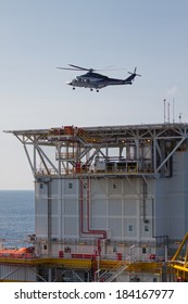 helicopter landing on an offshore oil-plant , service travel to oil and gas platform in offshore.