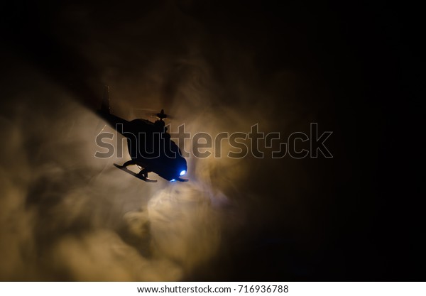 Helicopter over fire\
sunset horizon. War concept. Military scene of flying helicopter\
fire backgroung\
effect.