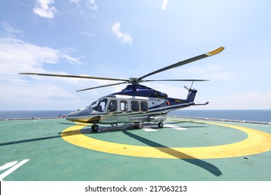 helicopter parking landing on offshore platform. Helicopter transfer crews or passenger to work in offshore oil and gas industry.