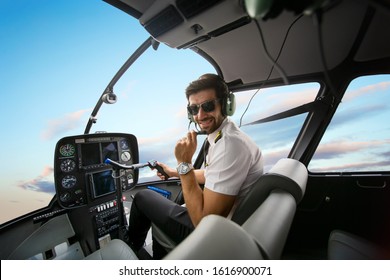 Helicopter Pilot  Sitting In Cockpit Flying Over Cloud Sky