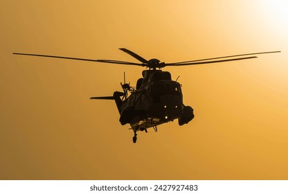 Helicopter silhouette against a stunning sunset sky, evoking a sense of adventure and freedom - Powered by Shutterstock