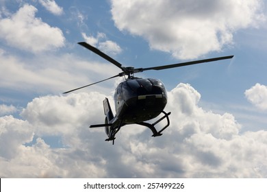 helicopter silhouette in the blue sky
