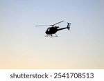 A helicopter tour with the setting sun and birds in the background.