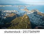 Helicopter view of the christ the redeemer statue in Rio de Janeiro at sunset above the city