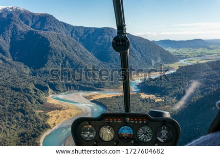 Helicopter window view of mountain valley with river. Luxury tourism, travel experience background 