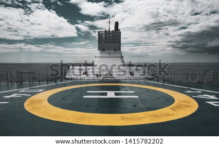 Helipad on board a Ship against a grey Sea