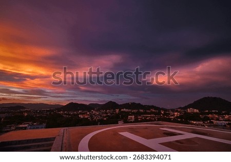 Helipad Overlooking Cityscape During Dramatic Sunset With Vibrant Sky Colors