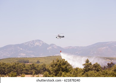 Helitack Dropping Water With A Bucket