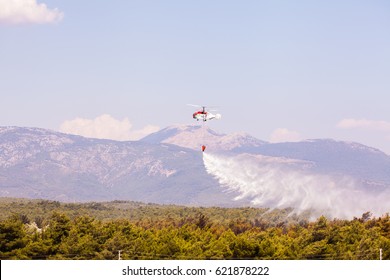 Helitack Flying Over A Forest Fire