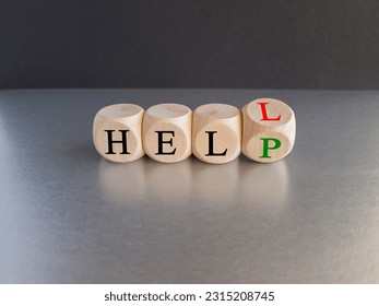 Hell or help symbol. Turned a cube and changes the word 'hell' to 'help'. Business, psychology and hell or help concept. Beautiful black background, gray table, copy space. - Shutterstock ID 2315208745