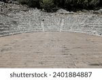 Hellenistic theatre remains -cavea, orchestra- dated in the mid-III c.BC thanks to the western parodos dedicatory inscription and others on the diazoma, Butrint archaeological site. Sarande-Albania.