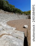 Hellenistic theatre remains -cavea, orchestra- dated in the mid-III c.BC thanks to the western parodos dedicatory inscription and others on the diazoma, Butrint archaeological site. Sarande-Albania.