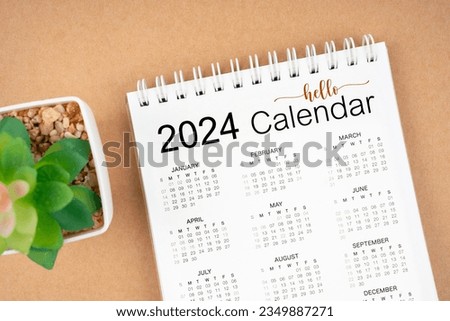 Hello 2024 calendar. 12 months desk calendar 2024 on brown background.