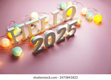 Hello 2025 alphabet letter with cotton ball LED decoration on pink background - Powered by Shutterstock