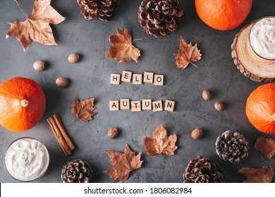 Hello autumn card with natural pine cones, pumpkins, dried leaves and pumpkin latte on dark grey stone top, top view, copy space. Fall, Thanksgiving background, cozy flat lay - Powered by Shutterstock