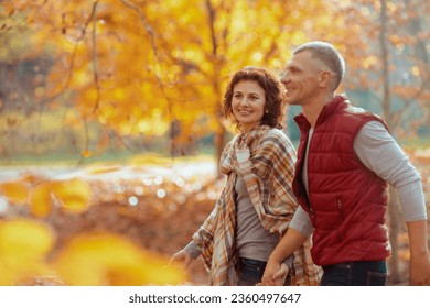 Hello autumn. smiling modern couple in the park walking.