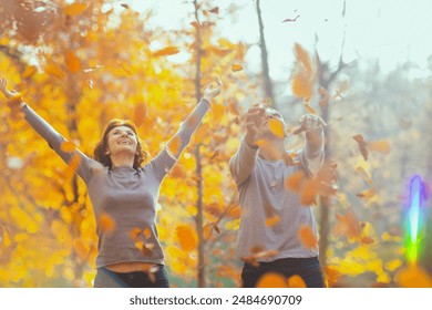 Hello autumn. smiling romantic family in the park throwing autumn leafs. - Powered by Shutterstock