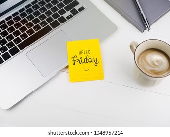 Hello Friday with smiley icon face on sticky note on desk - Powered by Shutterstock