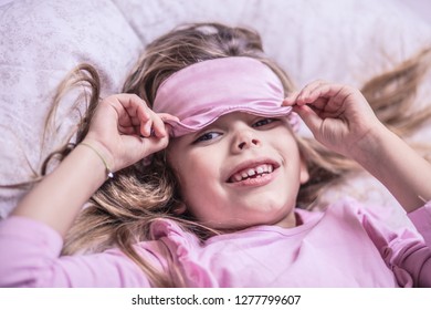 Hello. Little girl lying on bed. Looking at camera. Close up. - Shutterstock ID 1277799607