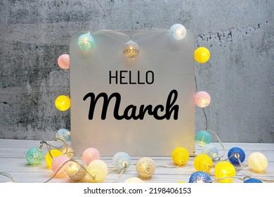 Hello March Text Message With LED Cotton Ball Decoration On Wooden Background