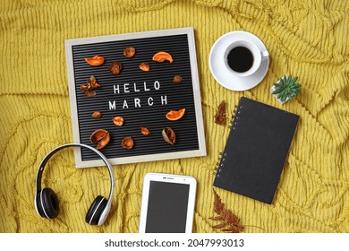 Hello March Written On The Letter Board With Multimedia Accessories And Coffee Flat Lay Concept