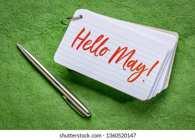 Hello May  - Handwriting On An Index Card With A Pen Against Green Textured Paper