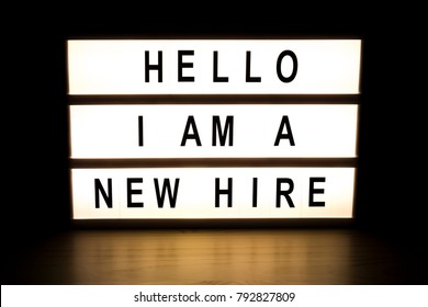 Hello I Am New Hire Light Box Sign Board On Wooden Table. 