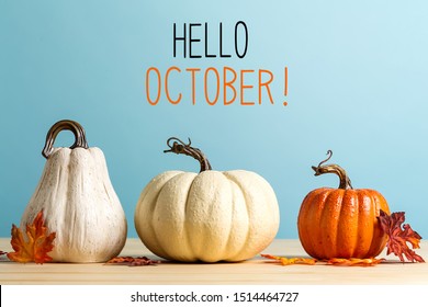 Hello October message with pumpkins on a blue background