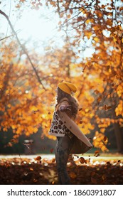 Hello October. Smiling Trendy 40 Years Old Woman In Beige Coat And Orange Hat Outside In The City Park In Autumn Rejoicing.