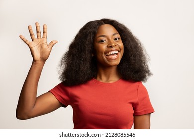 Hello. Portrait Of Joyful Young Black Woman Waving Hand At Camera, Cheerful Excited African American Female Gesturing Hi, Greeting Somebody While Standing Over White Studio Background, Copy Space - Shutterstock ID 2128085546