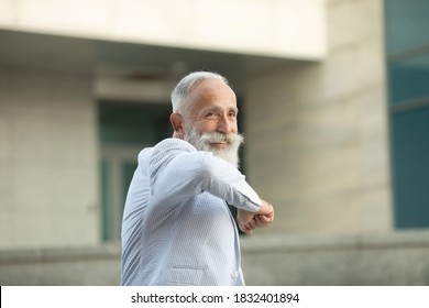 Hello! Portrait Of Positive Handsome Senior Business Man With Medical Mask Smiling Friendly And Waving Hand Saying Hi, Welcoming Gesture. Covid-19.